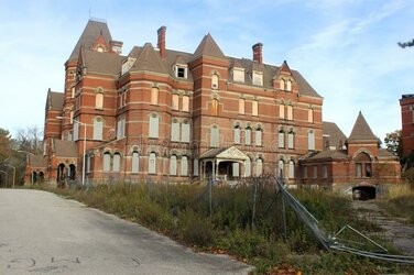 exterior-boarded-up-abandoned-brick-asylum-hospital-building-broken-windows-historic-campus-fa...jpg