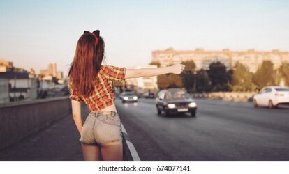 young-sexy-brunette-catches-car-260nw-674077141.jpg